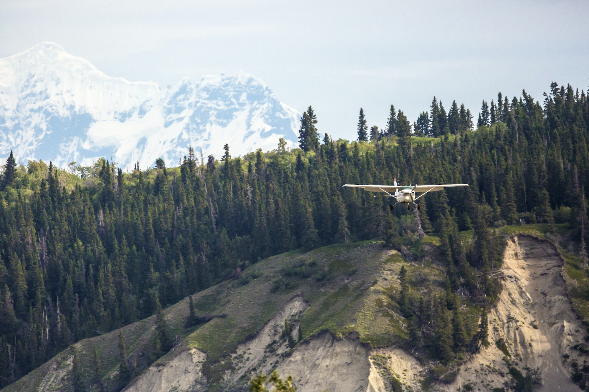Cessna flying near mountainous terrain — flight training in real-world conditions
